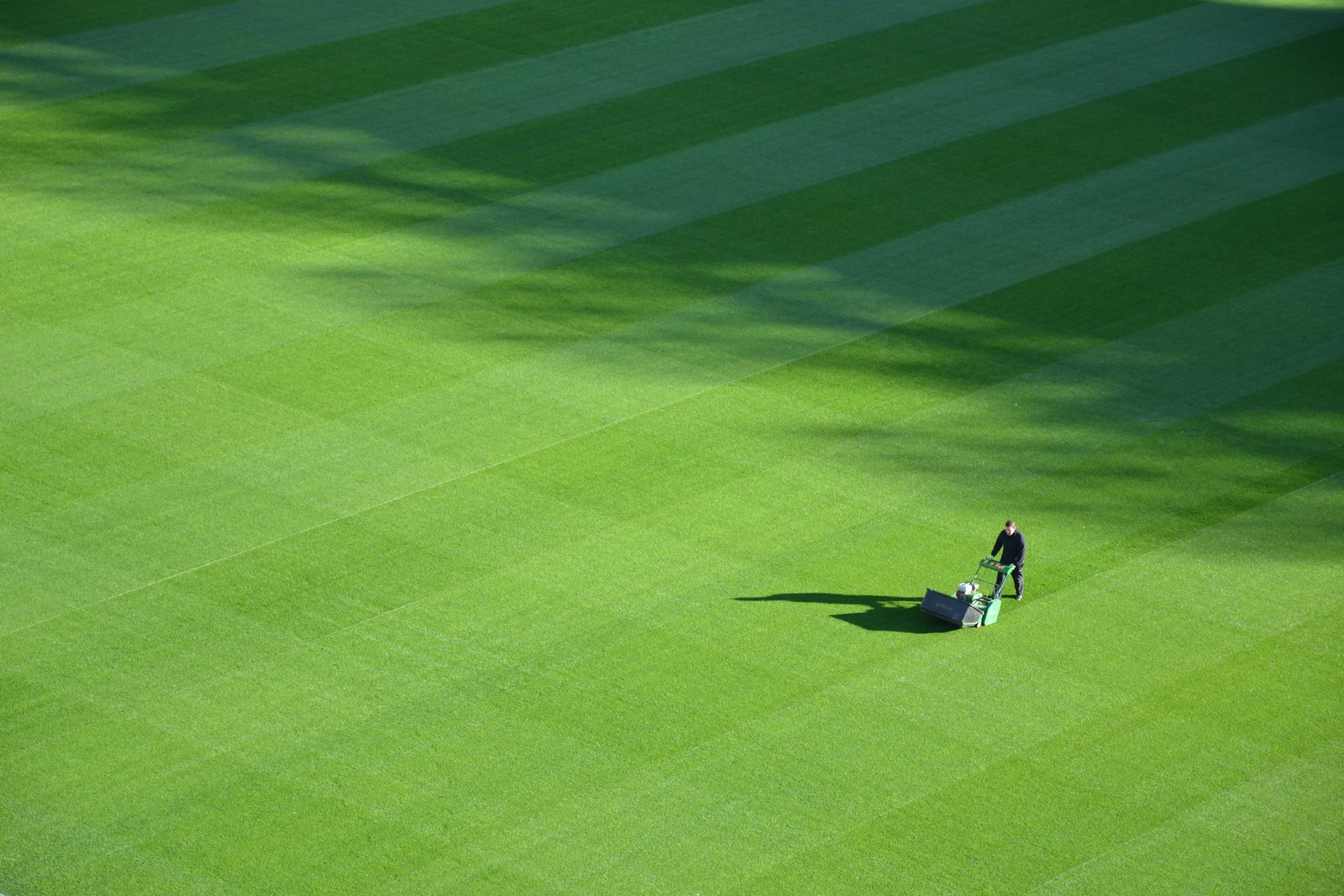 aerial photography of person mowing field during day